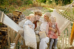 Cheerful family having fun on hammock, camping