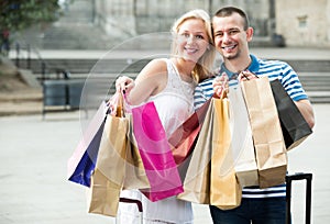 Cheerful family looking satisfied after shopping