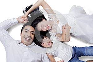 Cheerful family lying in studio