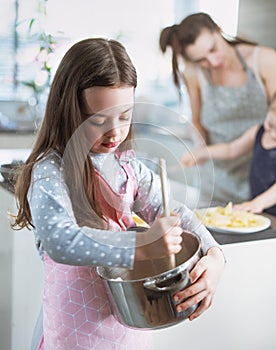 Cheerful family making crepes in the home kitchen