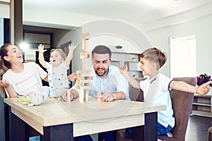 A family plays board games sitting at a table indoors. photo