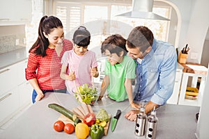 Cheerful family preparing salad