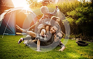 Cheerful family realxing on a camp