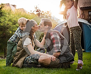 Cheerful family realxing on a camp