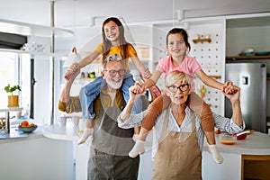 Cheerful family spending good time together while cooking in kitchen