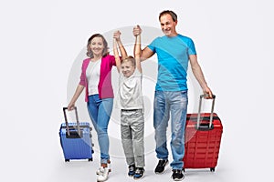 Cheerful family with suitcases ready for trip