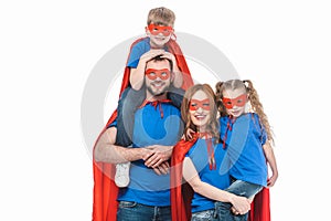 cheerful family of superheroes smiling at camera