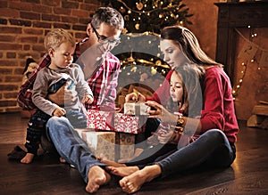 Cheerful family unboxing presents together photo