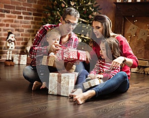 Cheerful family unboxing presents together photo