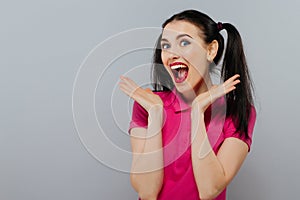 Cheerful fashion girl going crazy making funny face and dancing. Blue color background. hipster style