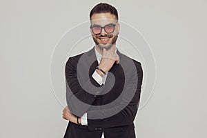 Cheerful fashion model laughing with hand on chin