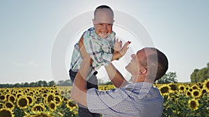 Cheerful father entertains son with Down syndrome on field