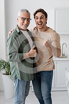 cheerful father and son showing like