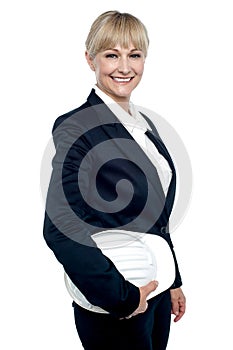 Cheerful female architect holding hardhat