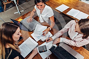 Cheerful female business partners having a meeting discussing sales strategies in a conference room