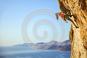 Cheerful female climber on challenging route