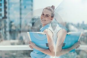 Cheerful female holding the documents in arms