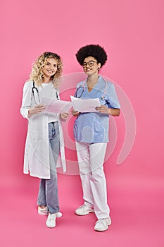 cheerful female oncologists, interracial doctors on