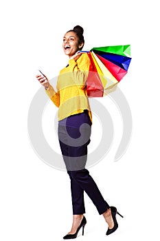 Cheerful female shopper with mobile phone