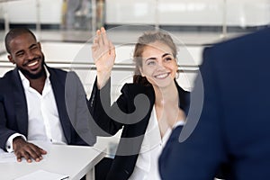 Cheerful female student asking questions business coach during seminar