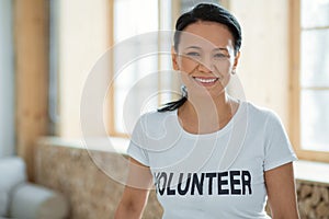 Cheerful female volunteer performing community service