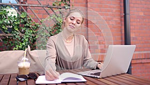 Cheerful freelancer using laptop in cafe