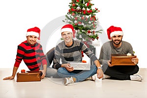 Cheerful friends with Christmas gifts