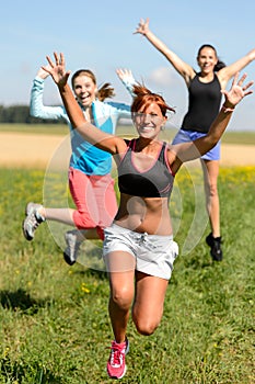 Cheerful friends jumping enjoy summer sport run