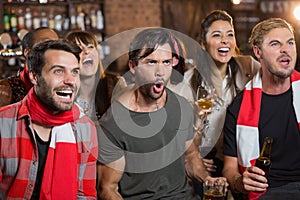 Cheerful friends shouting in pub