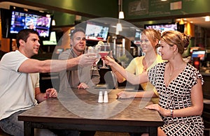 Cheerful friends toasting photo