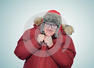 Cheerful funny man in glasses and winter clothes