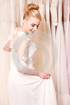 Cheerful future bride is wearing white dress