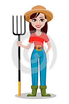 Cheerful gardener woman rancher holding pitchfork.