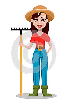 Cheerful gardener woman rancher holding rake.