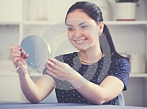 Cheerful gir looking in mirror