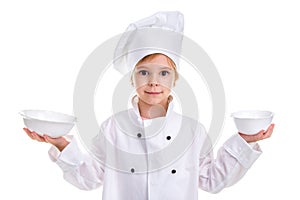 Cheerful girl chef white uniform isolated on white background. Holding two white drinking bowls in both hands. Landscape