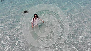 Cheerful girl at Cockburn island `s beach from high angle view