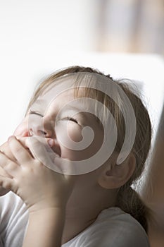 Cheerful Girl Covering Mouth With Hands