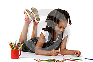 Cheerful girl draws pencil lying on the floor