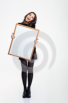 Cheerful girl holding blank board