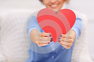 Cheerful girl holding heart