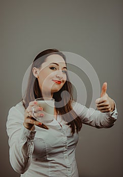 Cheerful girl holding milk mug in hand