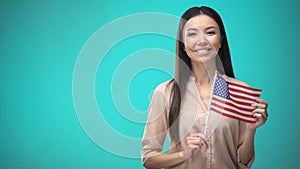 Cheerful girl holding USA flag, ready to learn foreign language, English school