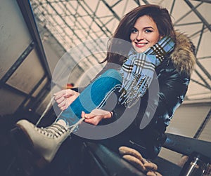 Cheerful girl on ice skating rink