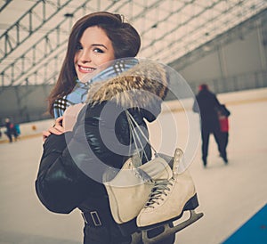 Cheerful girl on ice skating rink