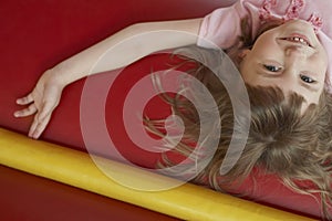 Cheerful Girl Lying In Bouncy Castle photo