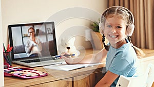 Cheerful girl during online lesson at home photo