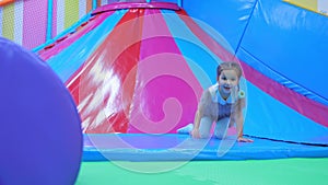 Cheerful girl playing in children s amusement park