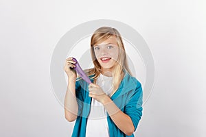 Cheerful girl posing with her handmade purple slime
