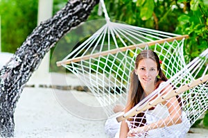 Cheerful girl relaxing in hammock